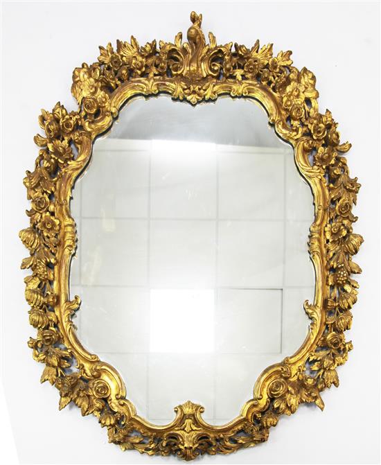 A pair of carved giltwood and gesso cartouche shaped wall mirrors, 4ft 7in. x 3ft 6.5in.